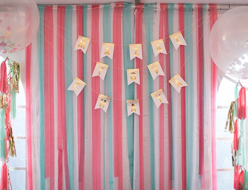 Mint and coral streamers backdrop for party